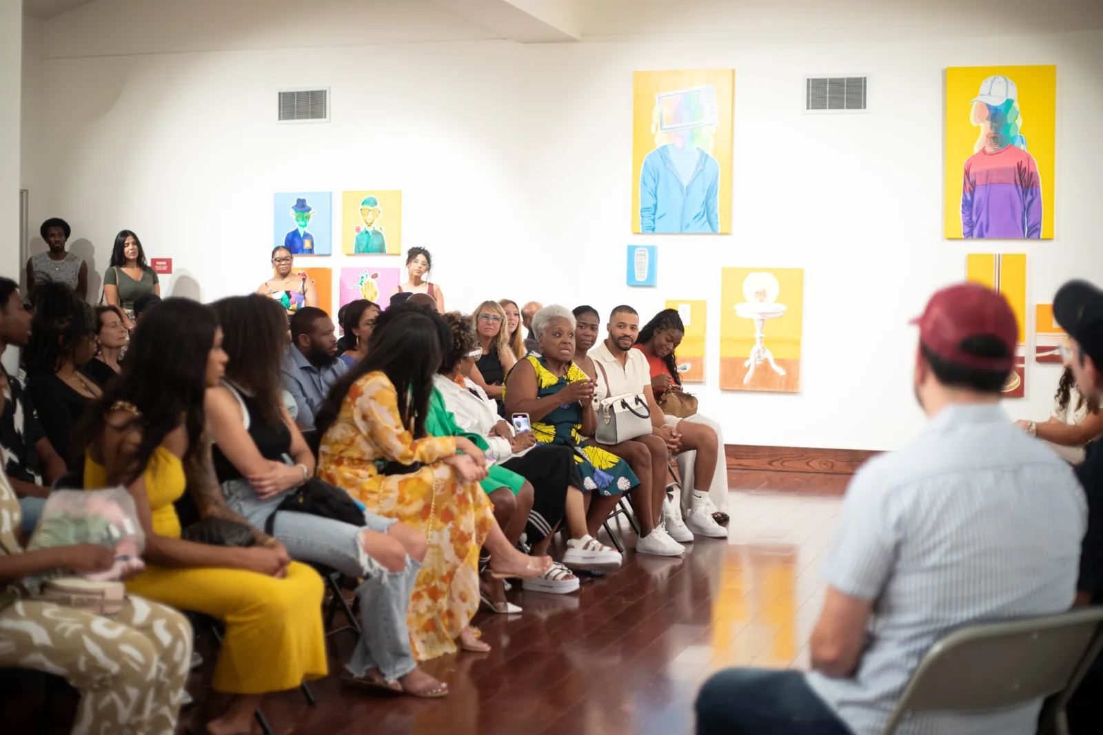 A full gallery audience during an artist conversation
